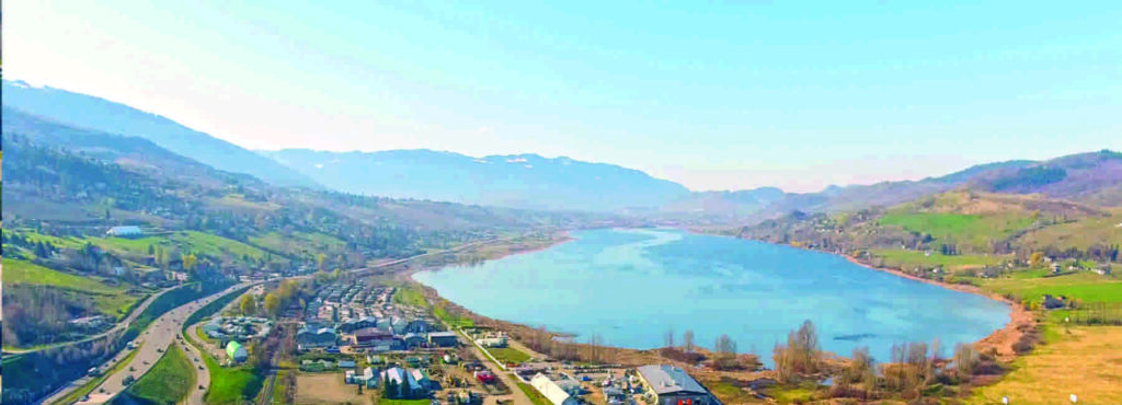 Swan Lake surrounded by fields and buildings